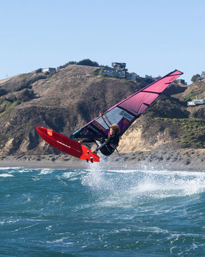 Red and purple Kode Windsurf Board with sail