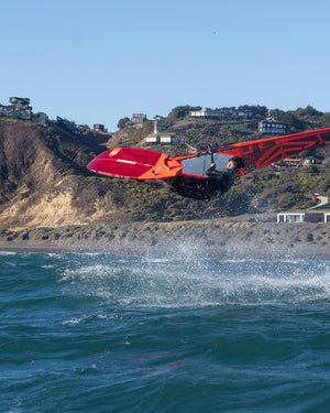 Red and black jet ski with orange accents on Kode Windsurf Board