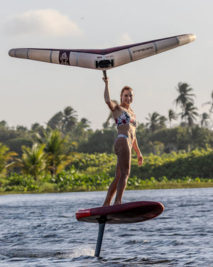 Sleek red Starboard Viva Wing hydrofoil board with black support leg