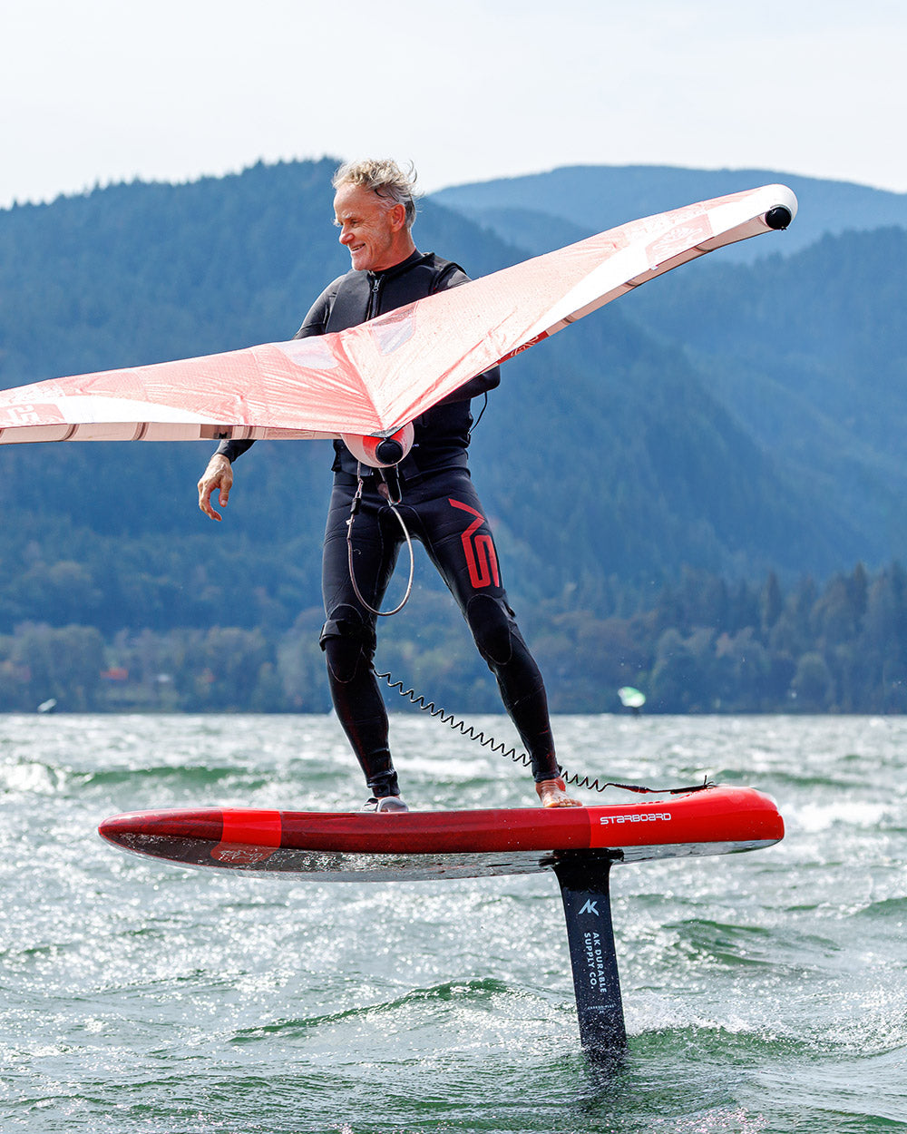 Red and black Stigerfo hydrofoil board with pink wing for Above Foilboard