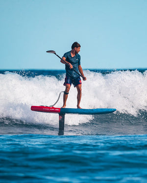 Ace Foil red and blue hydrofoil board with black paddle
