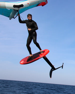 Sleek red iGnite Wing hydrofoil board with black fins