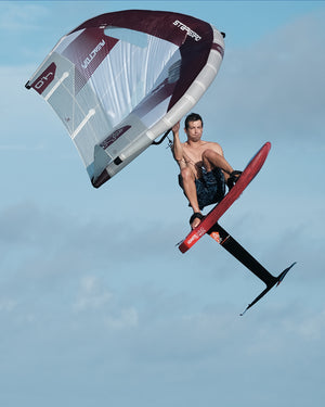 Maroon and white Starboard sail on iGnite Wing Foilboard