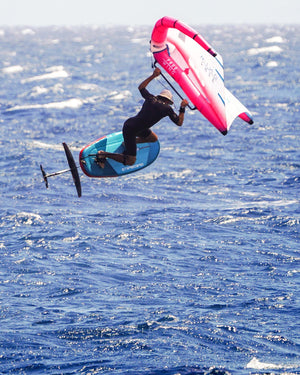 Starboard’s innovative Take Off Air Foil inflatable foilboard with pink and white sail and blue board