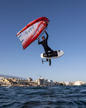 Red and white nylon windsurfing sail with black accents for 2025 Take Off Foilboard