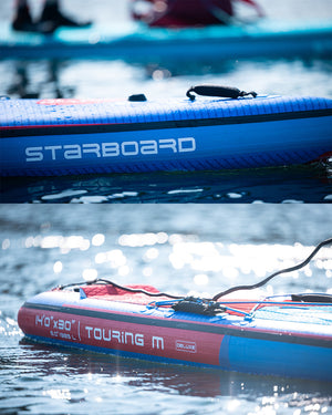 Blue Starboard Touring inflatable paddleboard with red accents and carbon fiber design