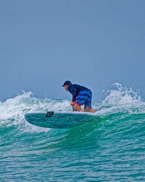 Blue and white striped Wedge Paddleboard with black leash