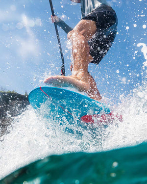 2025 Longboard SUP: Blue HDPE paddleboard with red fins and black leash