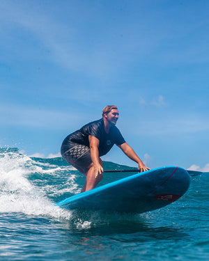 2025 Whopper Paddleboard with blue surfboard, red logo and black grip tape