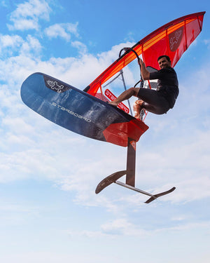 Sleek red and black foil freeride windfoil board with carbon fiber construction