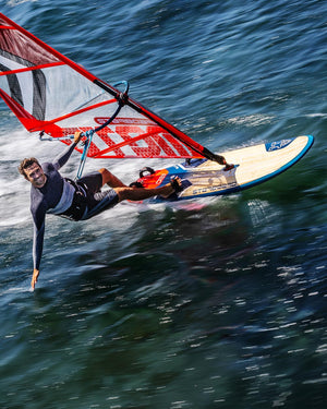 Red and white high-performance windsurfing sail with blue trim for 2025 Futura Board