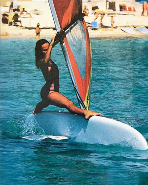 Windsurfer LT windsurf board with colorful sail and white deck