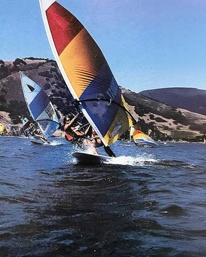 Windsurfer LT windsurf board with colorful blue, yellow, red sail