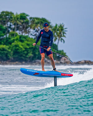 Ace Air Foil Inflatable Foilboard with blue hydrofoil, red fins, black paddle