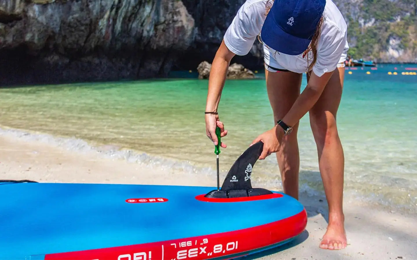 Blue and red inflatable SUP with black fin in 6-step installation guide
