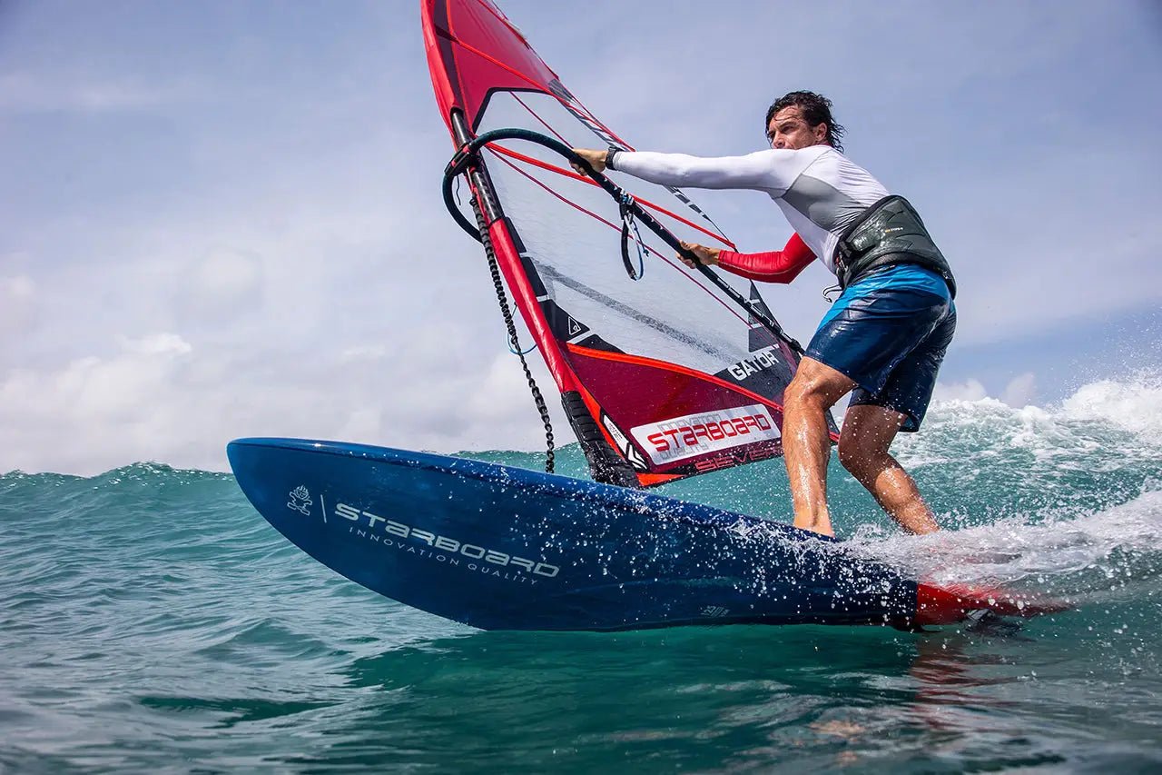 Kode blue and red starboard windsurfing board with white sail