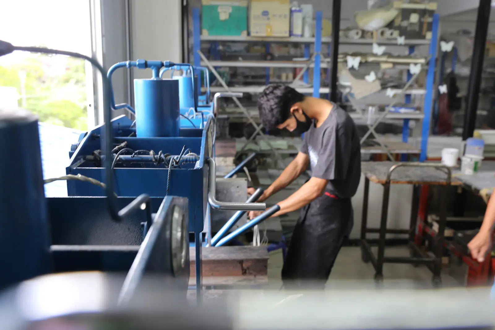 Blue industrial machine in SUP paddle manufacturing