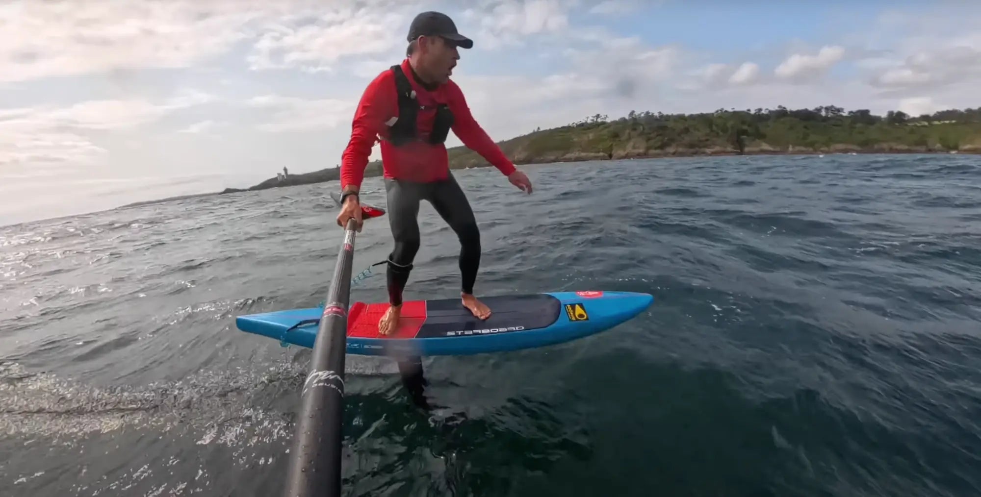 Blue and red Starboard Ace Foil Lightning SUP with black leash