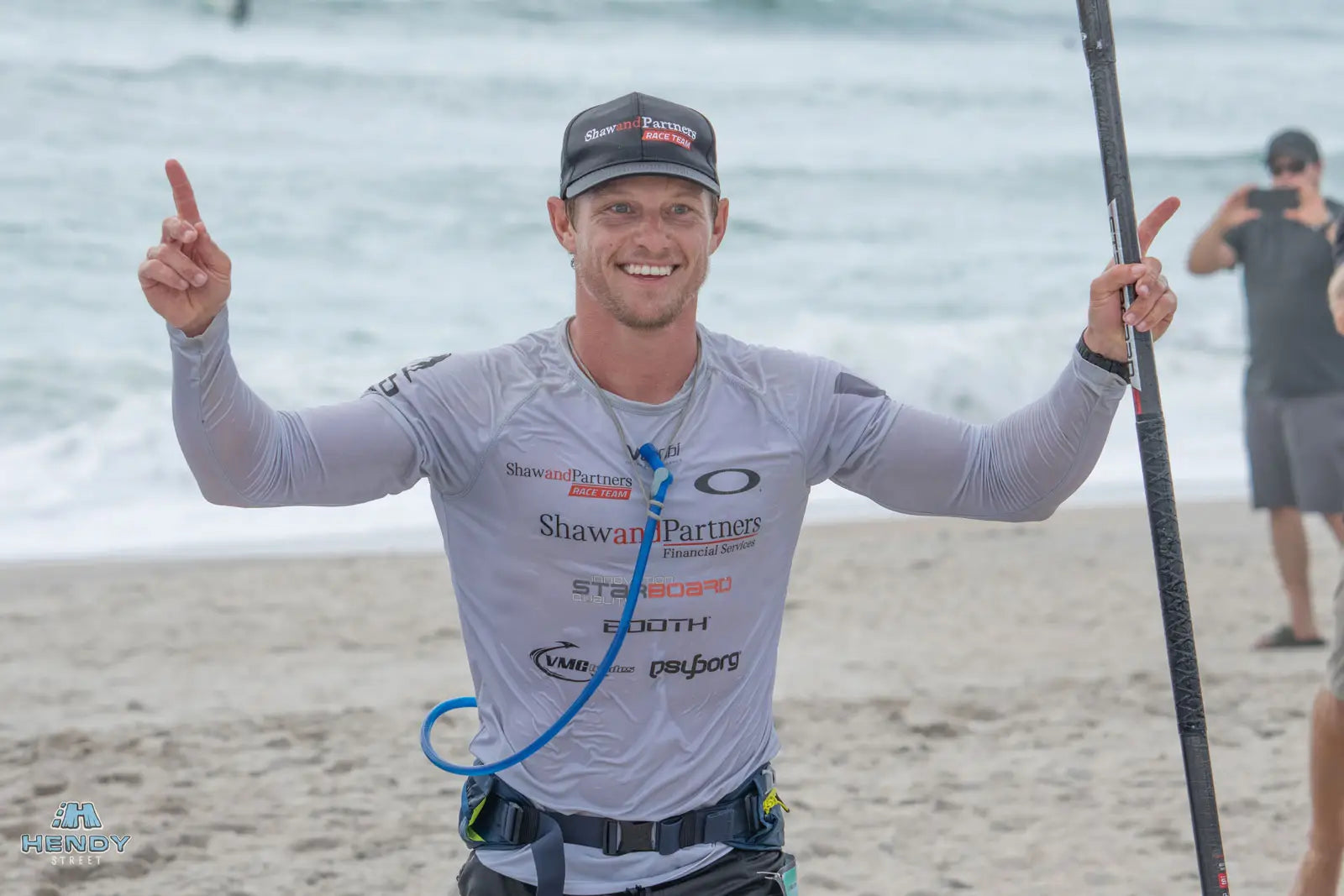 Booth’s black and white long-sleeved rash guard with sponsor logos