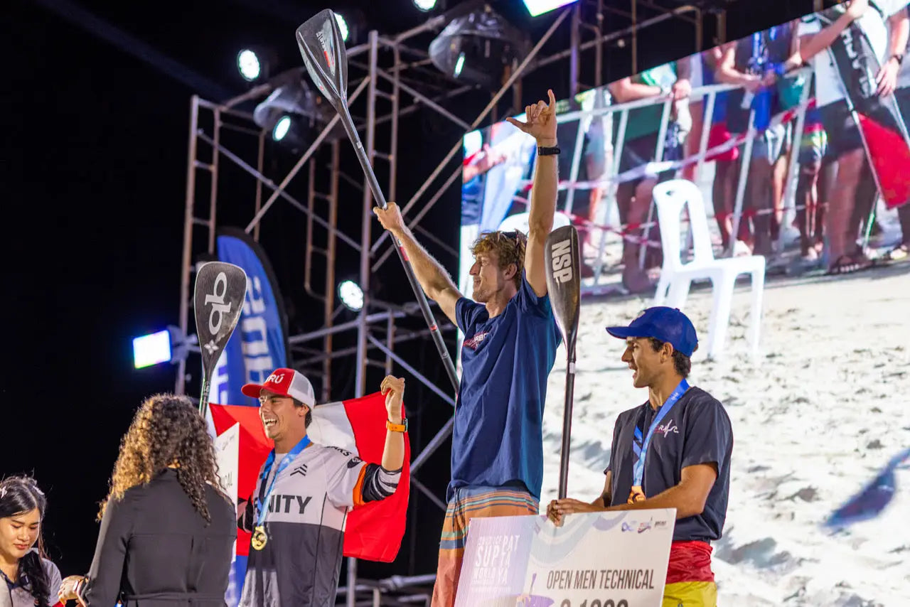 Connor Baxters blue and white fiberglass surfboard with red fins