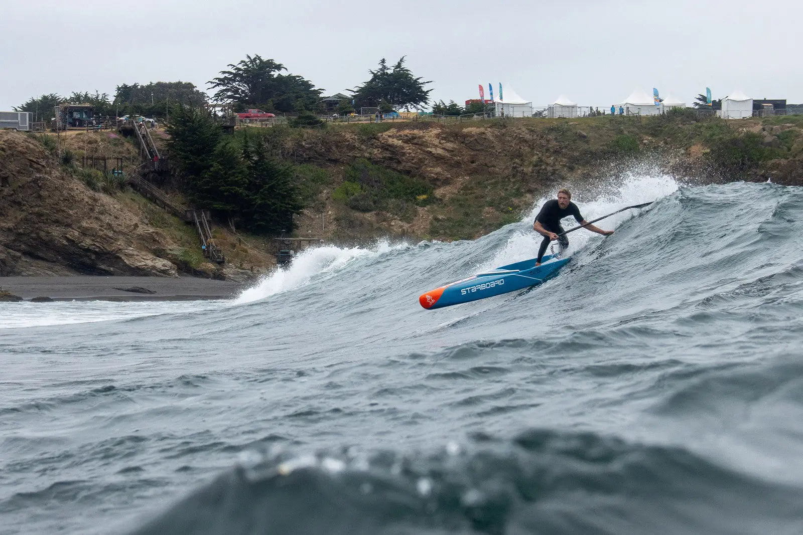Connor Baxter’s blue and orange SUP paddleboard with black fins