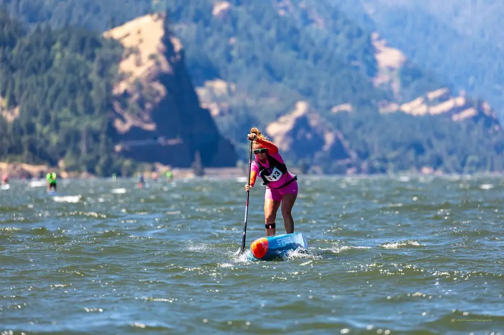 Fiona Wylde with blue and white paddleboard and red buoyancy aid