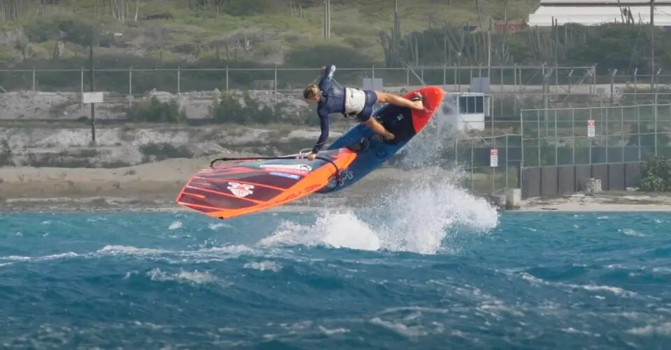 Orange and blue surfboard with white design in Aruba session