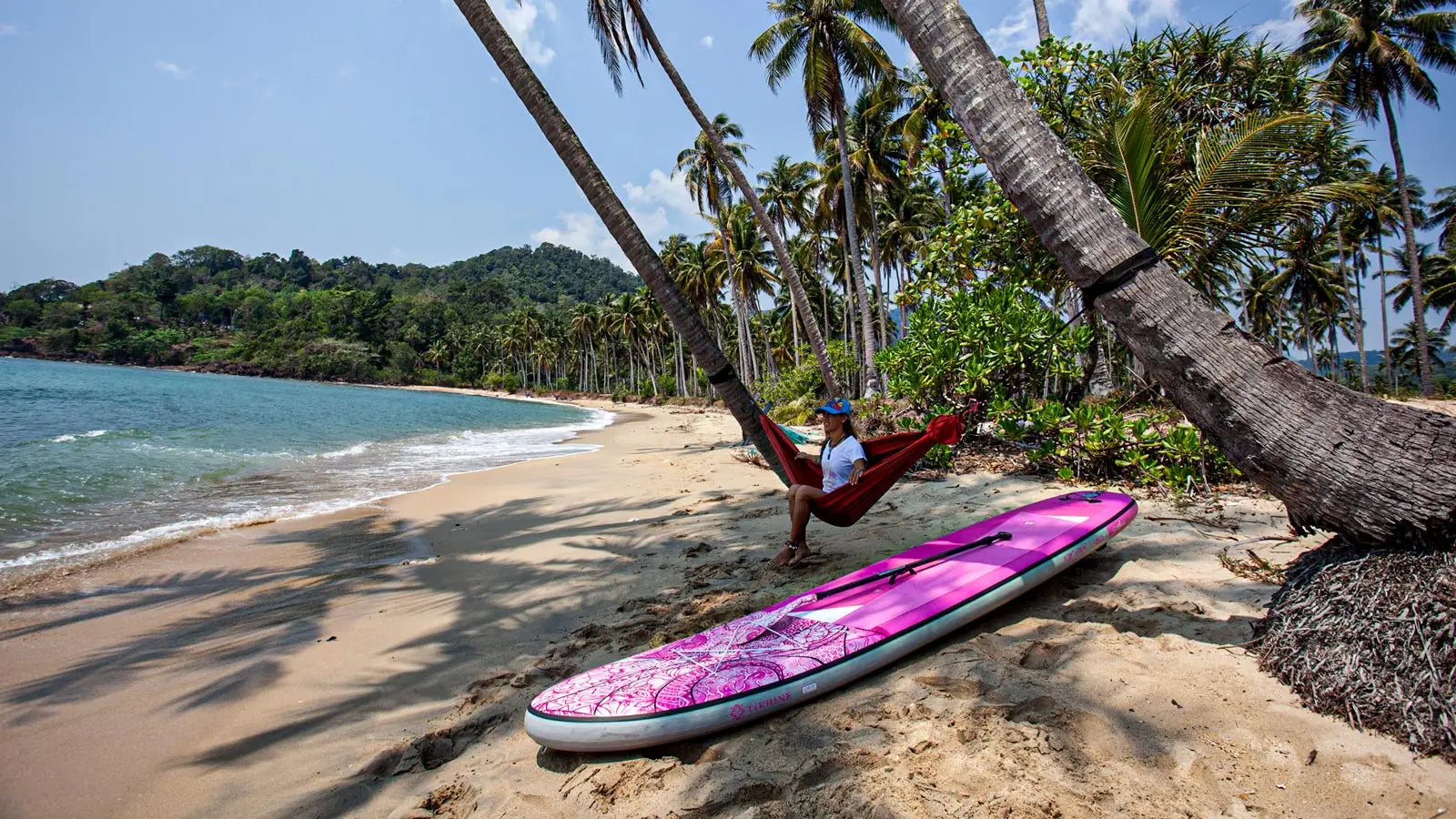 Pink surfboard with white and blue design for paddle boarding