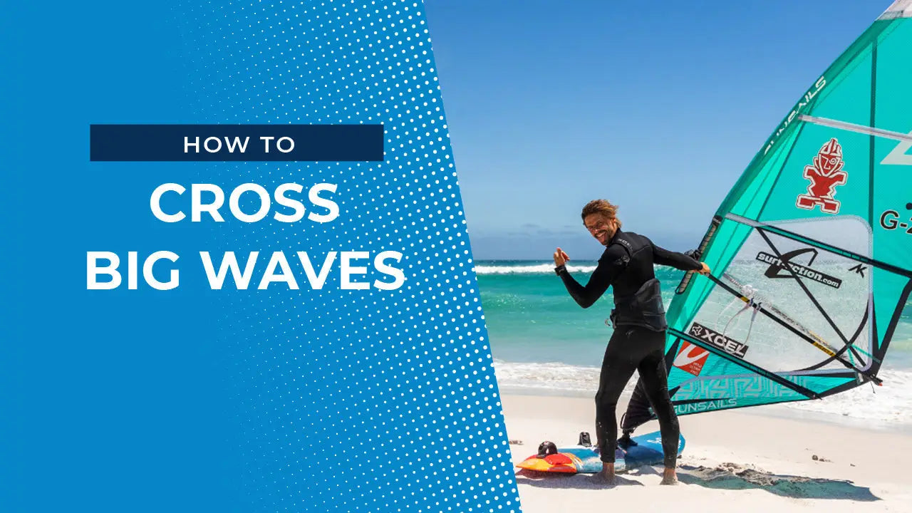 Windsurfer crossing big waves on board with teal sail and black wetsuit