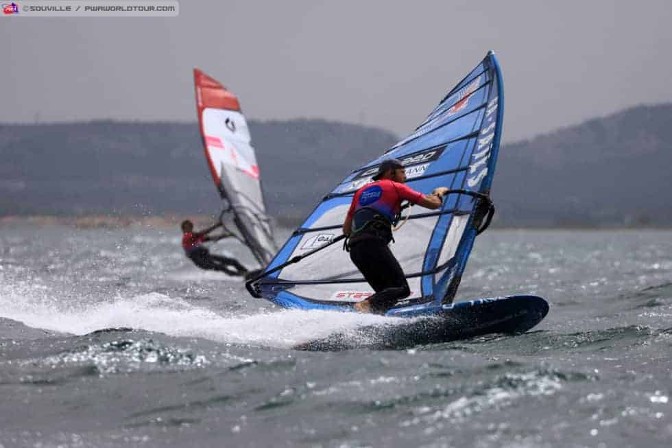 Blue iSonic windsurfing board with red and white performance sail