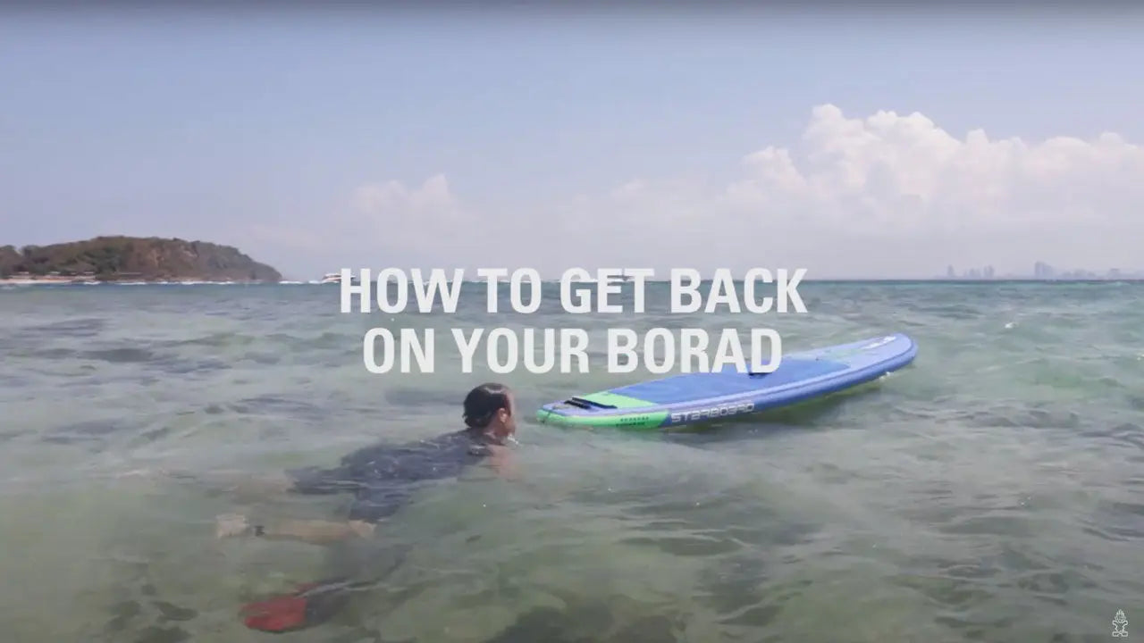 Blue and green inflatable stand-up paddleboard with red leash
