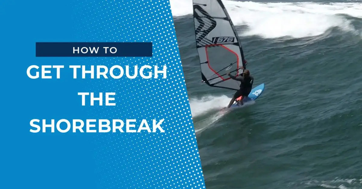 Windsurfing board with blue white design and red sail in shorebreak