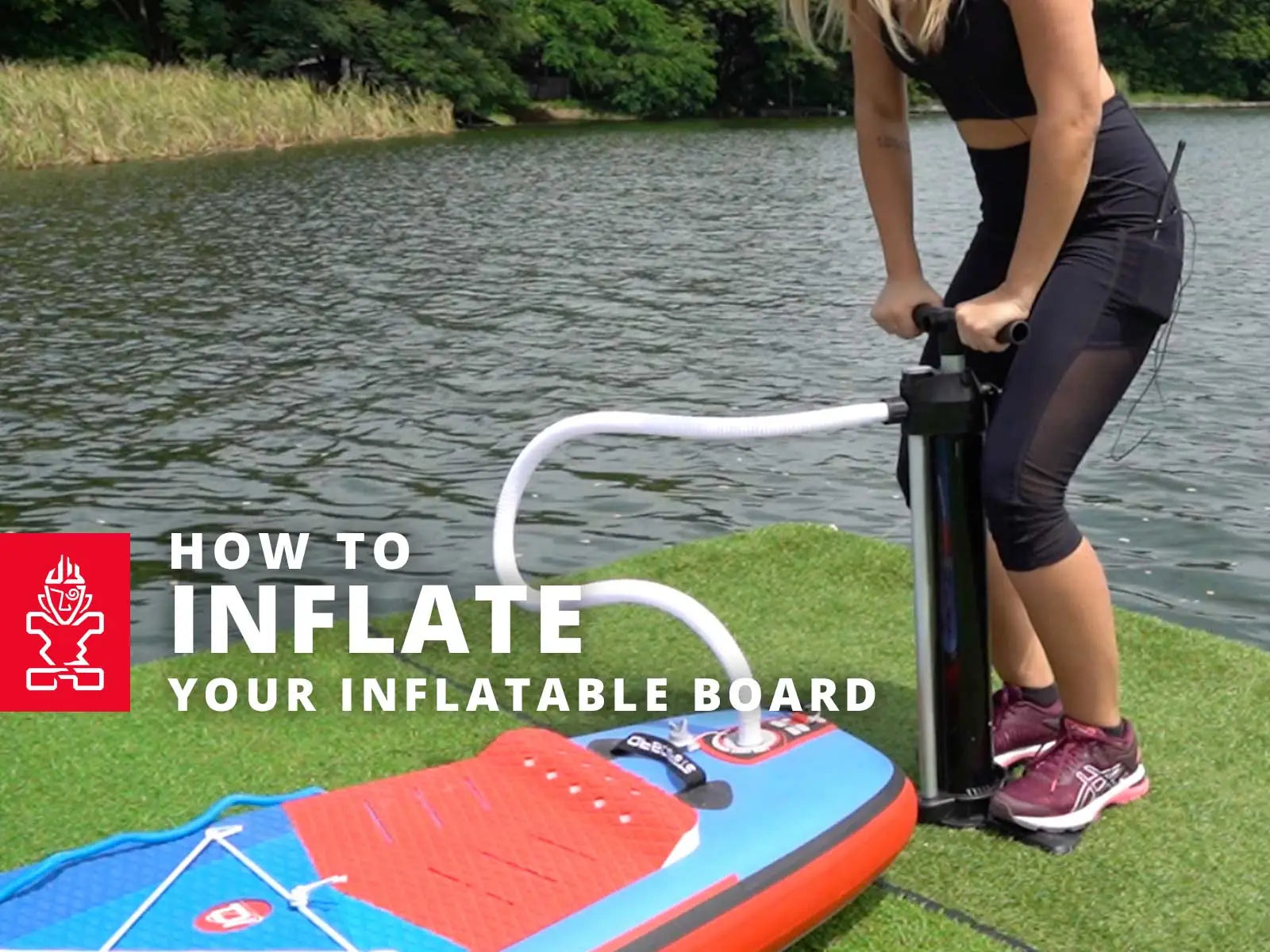 Inflatable Starboard SUP paddleboard with red and blue design and white pump handle