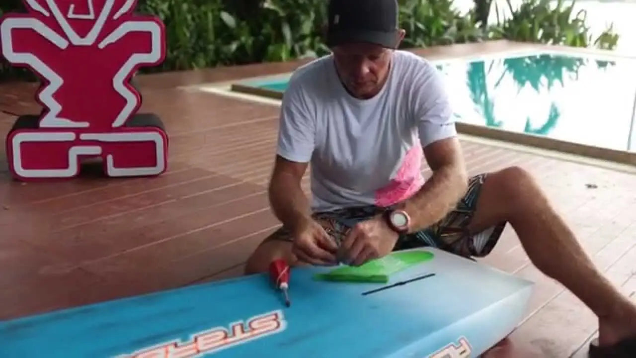 Blue polyurethane surfboard with white and red fin design