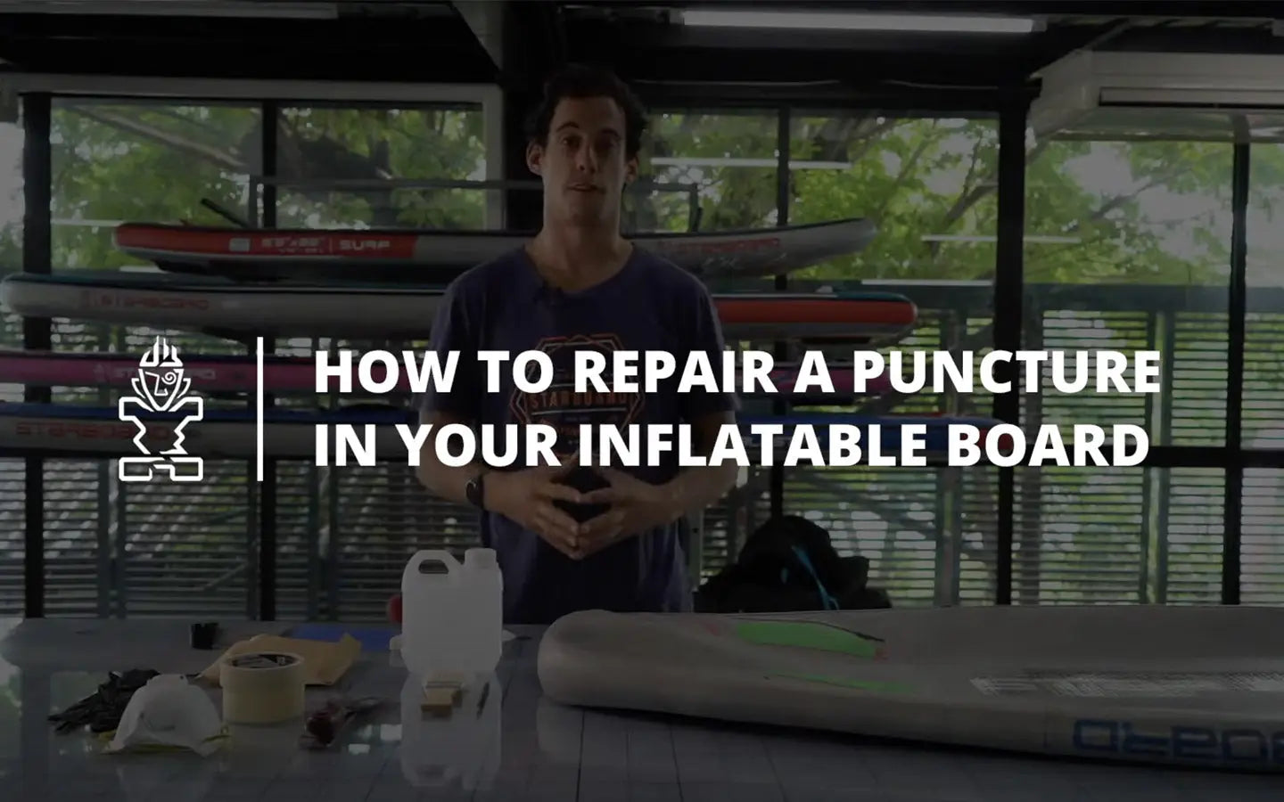 Blue and white inflatable paddle board with Ol-Pop logo in repair article