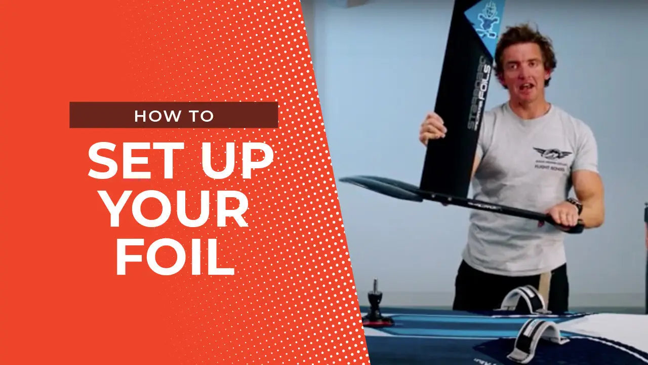 Black and white foil wing with blue accents for windsurfing setup