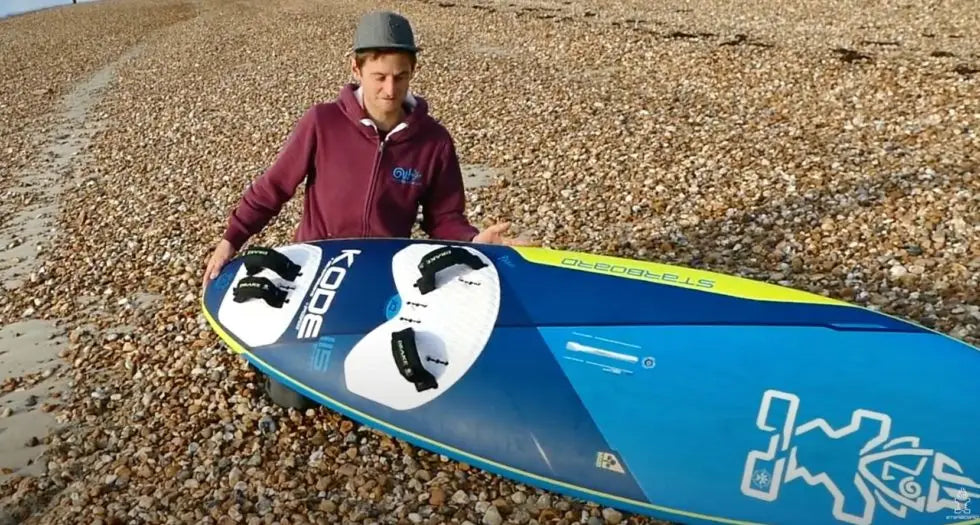 Blue and white Kode paddleboard with black fins for freeride setup
