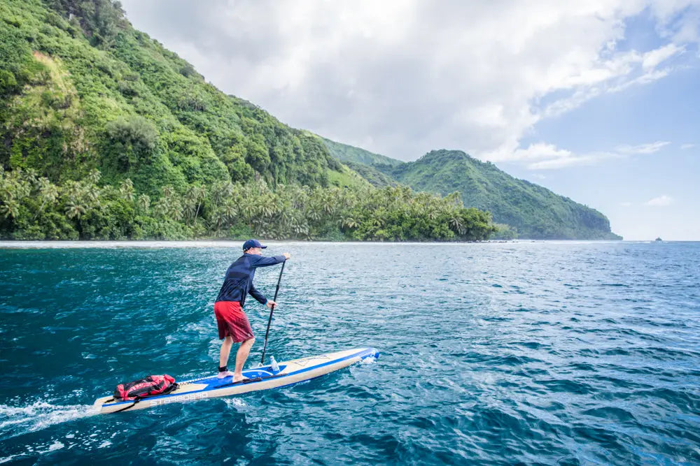 Blue and white stand-up paddleboard with red leash for SUP planning