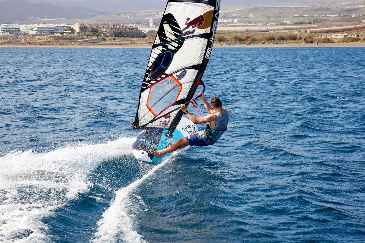 Red Bull windsurfing board with blue and white sail for high performance
