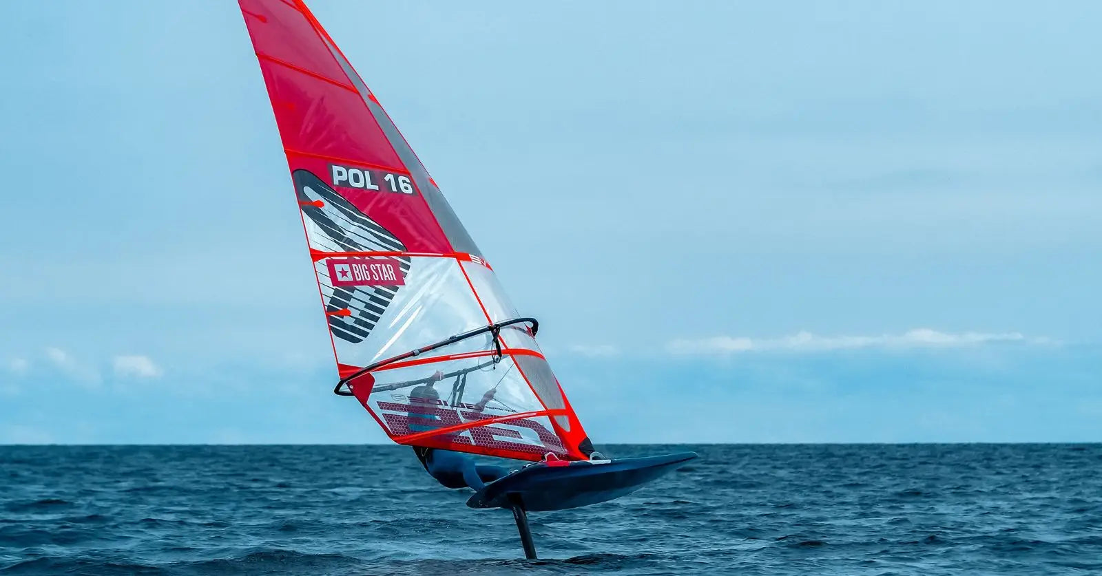 Michal Polanowski’s red and white high-performance windsurfing sailboard on Millennium