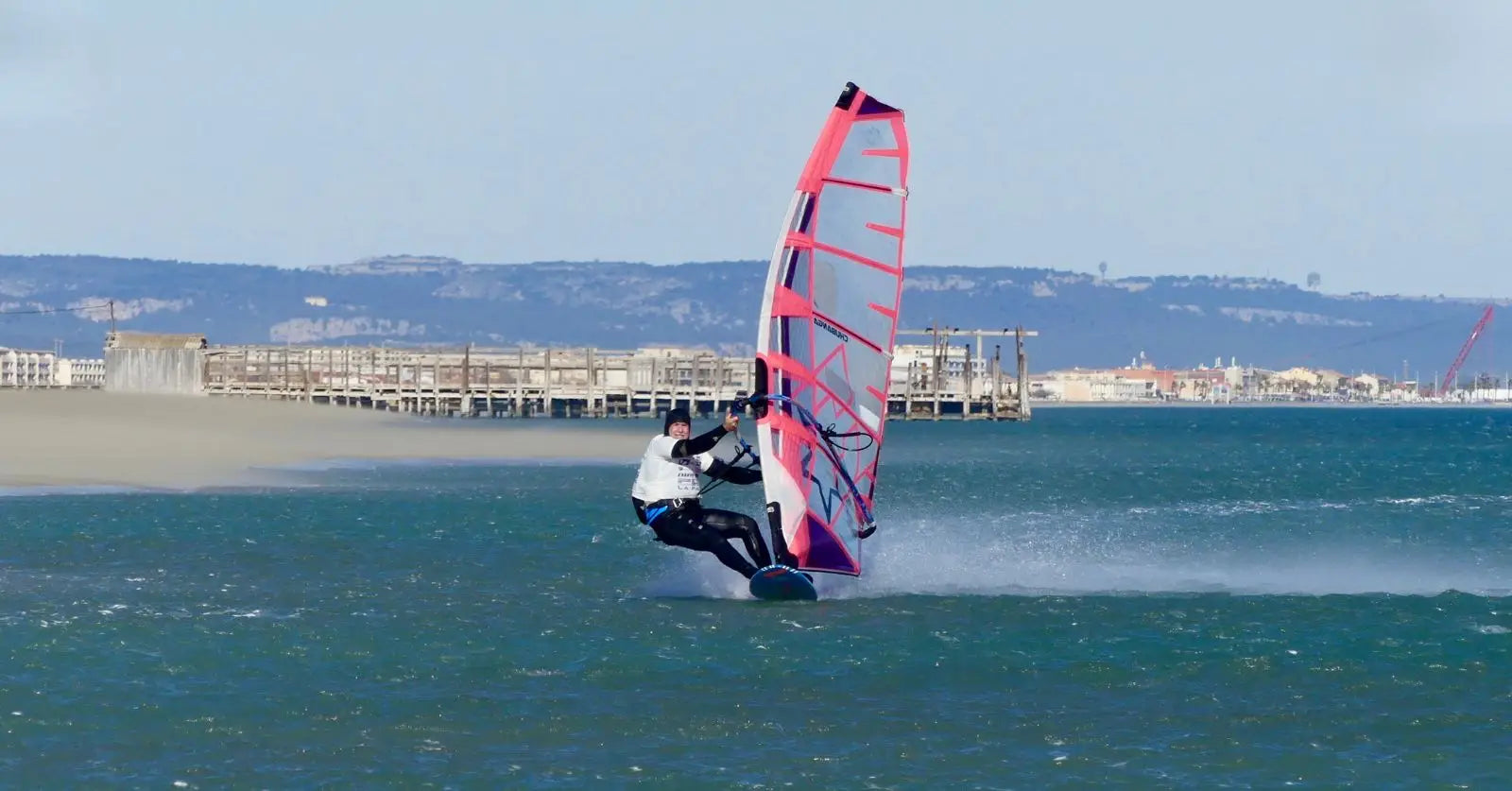 Pink and purple high-performance windsurfing sail with black accents for Principe Baldini