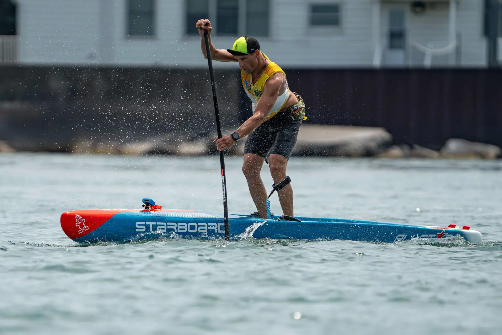 Starboard paddle board with red and blue accents, black leash, Niagara Classic race.