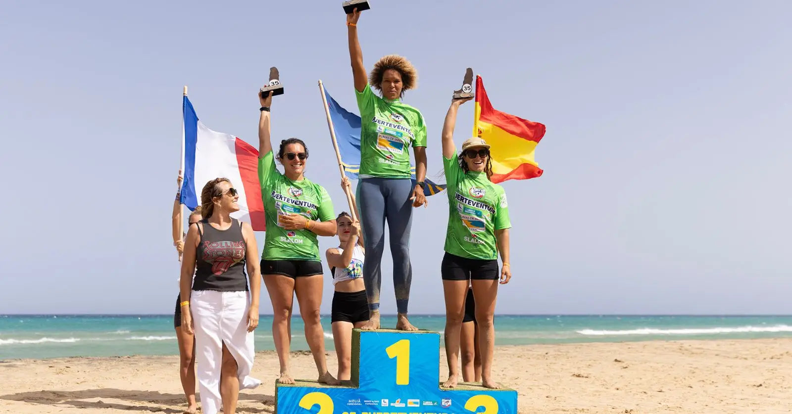 Green podium with flags on beach sand at PWA Fuerte World Cup