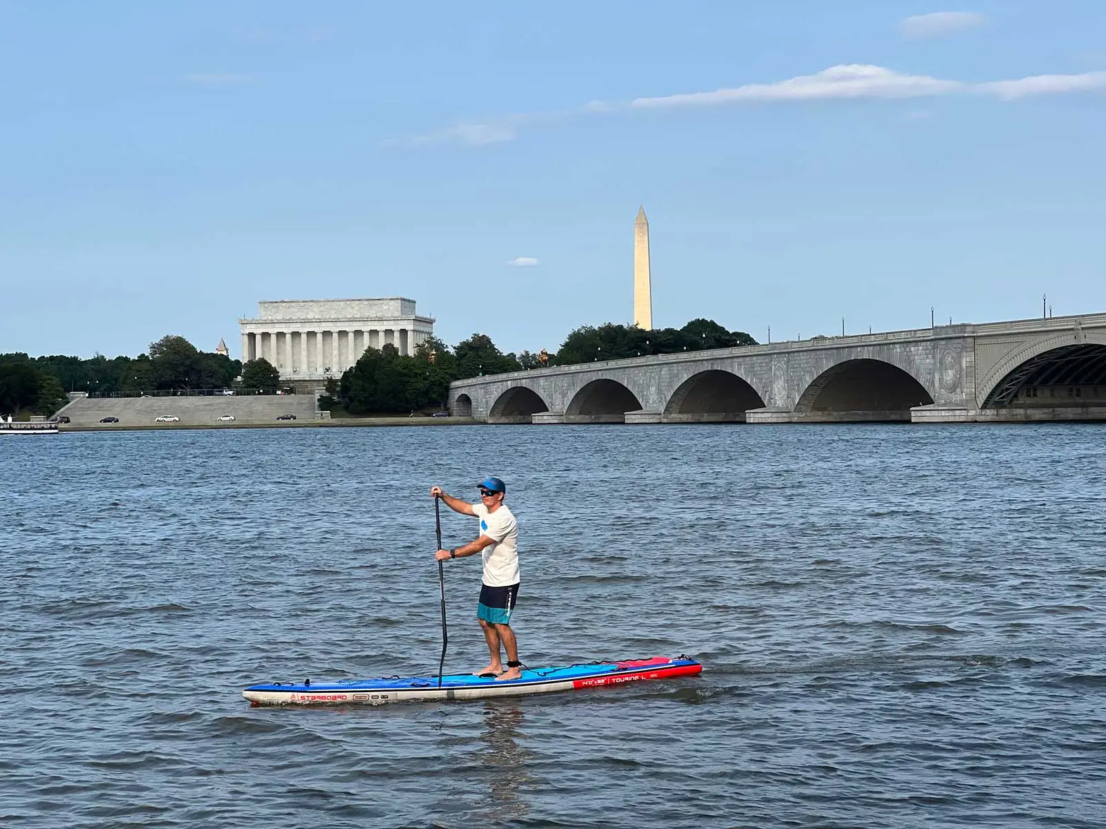 Red and blue composite paddleboard with white stripes in Washington DC