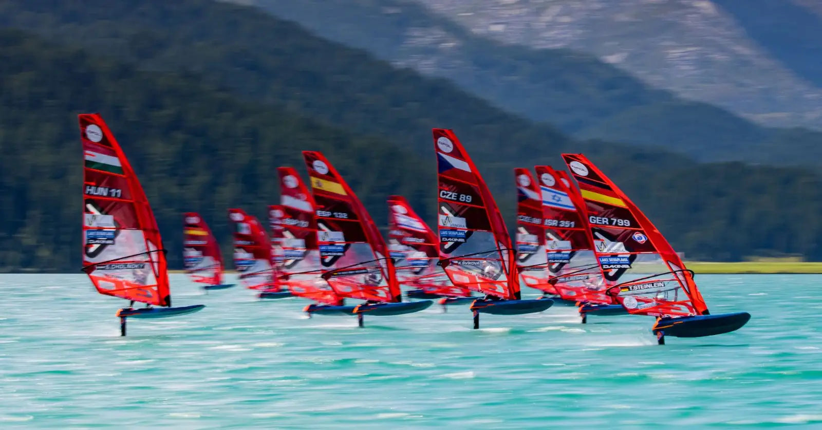 Red and white iQFOiL windsurfing board with black fins for Paris 2024 racing