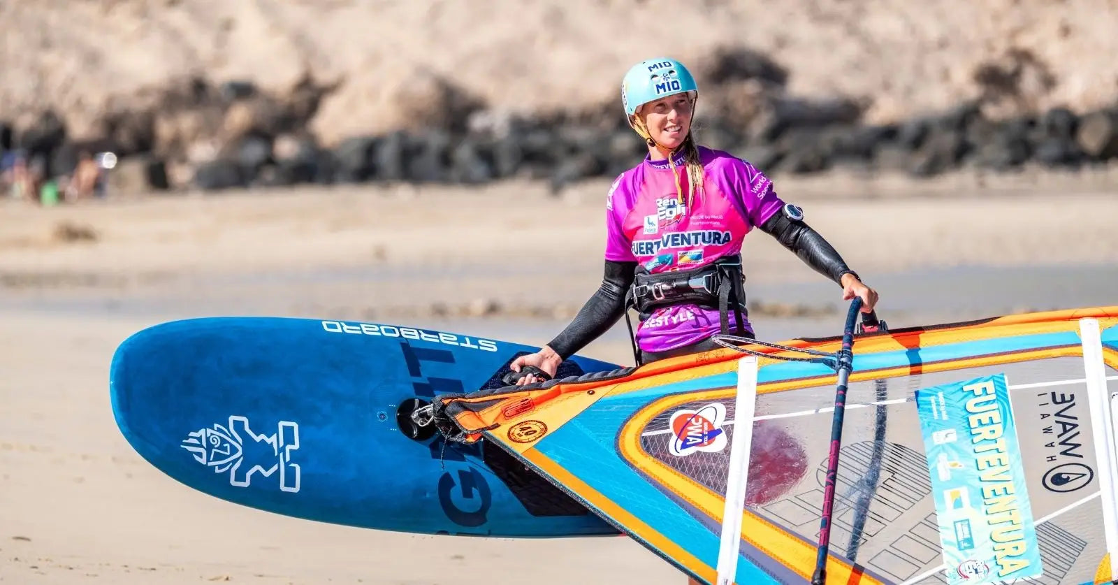 Lisa Kloster on vibrant blue Starboard windsurfing board