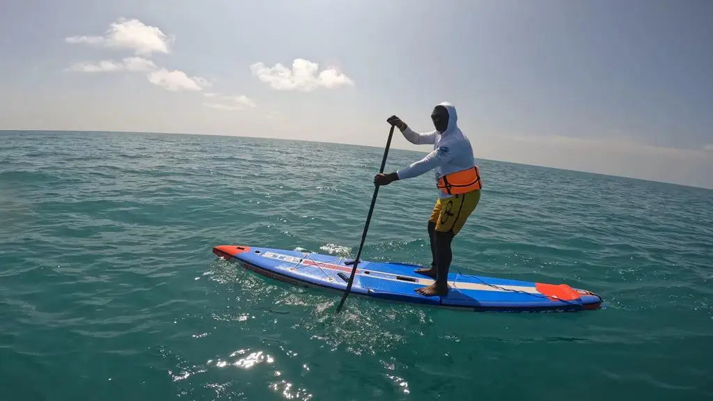 Sathish Kumar’s blue and orange SUP with red fins for water sports