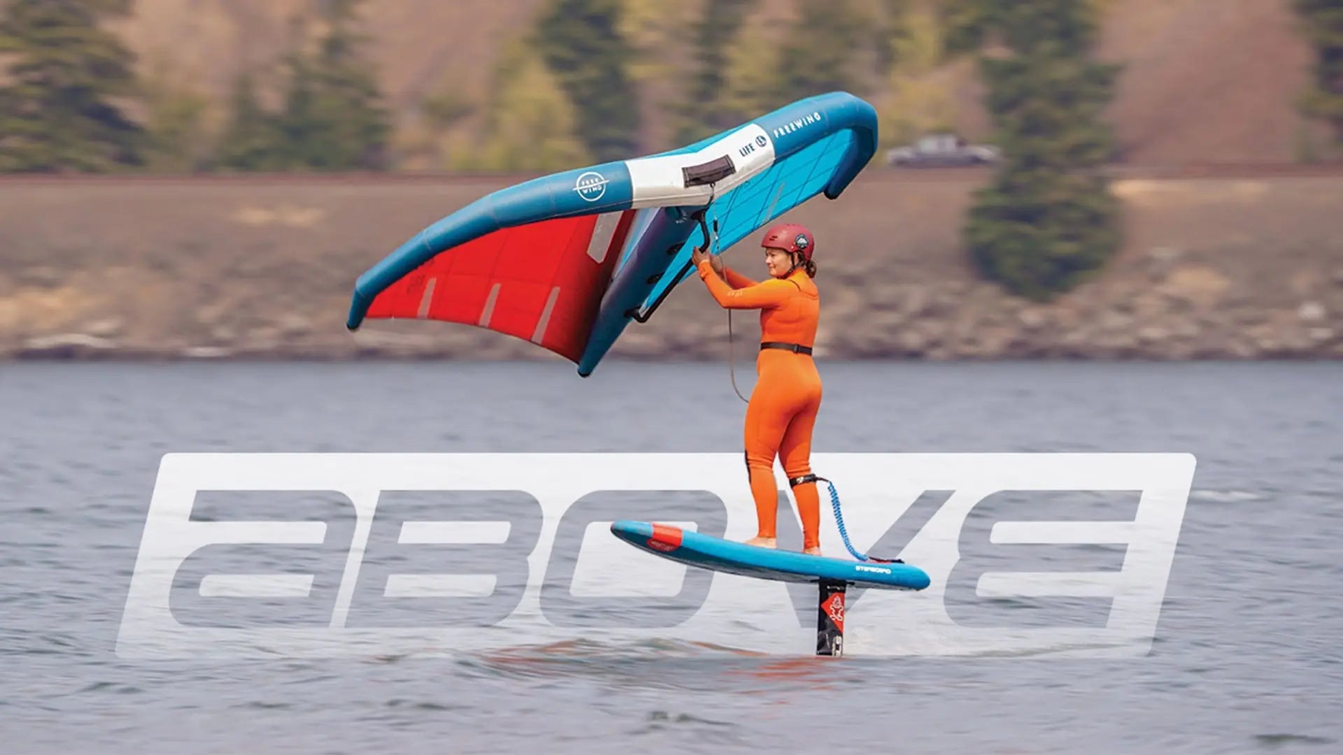 Starboard Above Range blue and red hydrofoil board with orange fins.