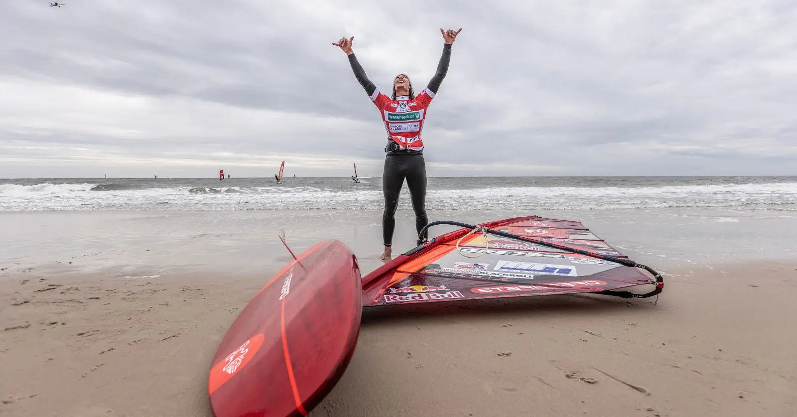 Red Starboard windsurfing board with black fins at PWA World Cup Sylt 2025
