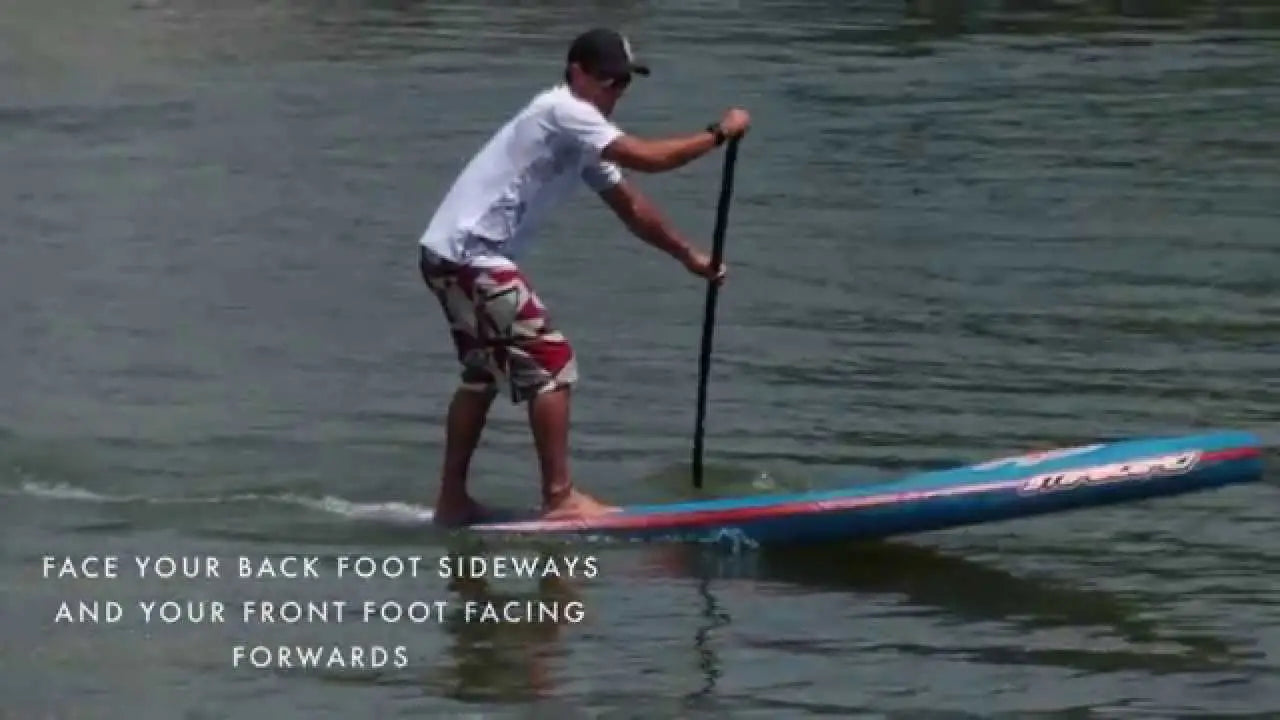 Stand-up paddleboard with blue-red design and white text for racing techniques